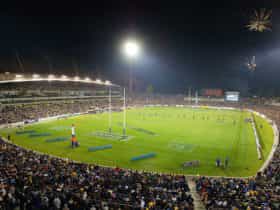 A packed stadium at night