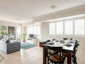 Lounge and dining rooms with lounge, TV, dining setting and air-conditioning