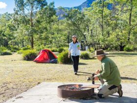 Campers use fire ring facilities at Kedumba River crossing campground, Blue Mountains National Park.