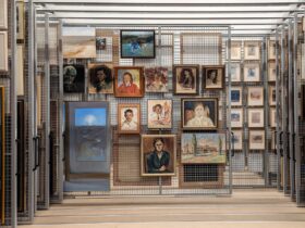 A collection of ten paintings from the Bundanon Collection hanging on a wire pull out rack