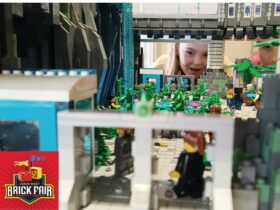 Young girl peering through window of Lego City