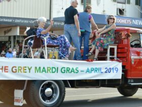 People in vintage costume on a truck for a parade in Cobar