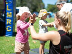 Little girl high fiving at Women in Sport Try a Sport Day