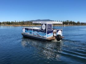 Mal's BBQ Boat drives along Wagonga Inlet in narooma