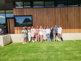 Group of friends posing for photo outside Shaw Wines on a Merry Heart CBR Great Tour