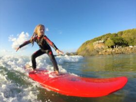 Kid surfing with Trent Munro Surf Academy in South West Rocks, Macleay Valley Coast