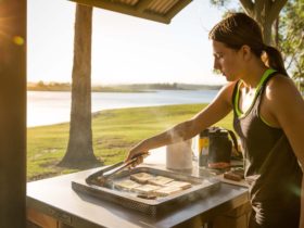 A woman cooking with views of Lake Samsonvale, Bullocky Rest