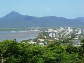Elevated view of Cairns city, Trinity Inlet and mountains in background.