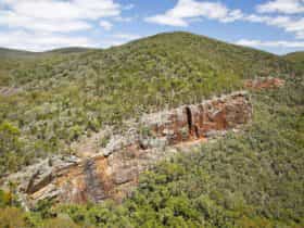 View of gorge and red, treeless cliff faces.
