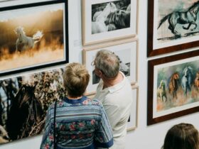 Visitors look at artworks featuring horses in the 2023 Seeing the Soul Exhibition