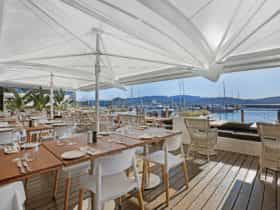 The Waterfront Deck –formal dining seating with stunning waterfront views.