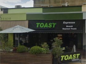 photo showing the faced of Toast Espresso bar with its outdoor seating on the street side
