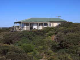 View of house set high amongst surrounding coastal vegetation
