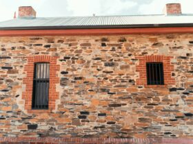 Once a horse stable; the Heritage exterior showcases original crimson brick and masonry stone.