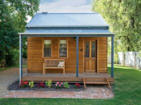 photo of exterior of wooden cabin in garden setting