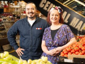 Katie Spain and Adam Liaw stand amongst Fresh Produce