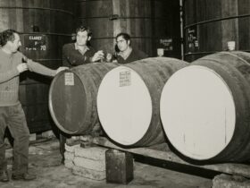 Patritti brothers tasting port from large barrels