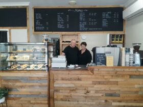 David and Kerrie, owners of the Bean n Blend coffee shop behind a pine counter with yummy cakes.