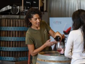 Belinda pouring The Outlier Grenache during a tasting with a young lady