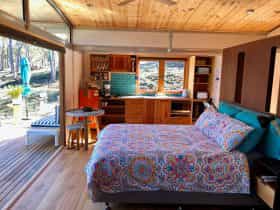 Free Spirit Pod living area and bifold door opening onto vast timber deck.