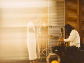 An abstract photos of two musicians with a golden hue