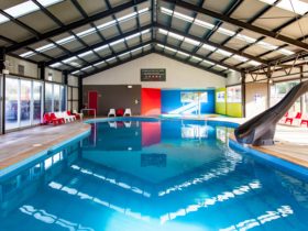 Heated swimming pool with slide