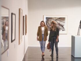 Two women looking at artwork