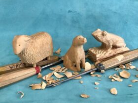Wooden carvings of a sheep, dog and frog