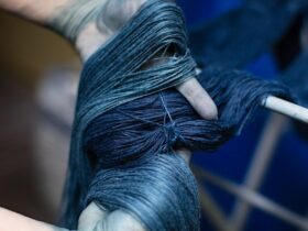 Hands holding fibres dyed in indigo