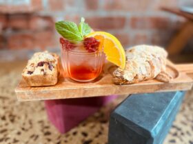 A glass of punch, pastries balancing on pilates blocks