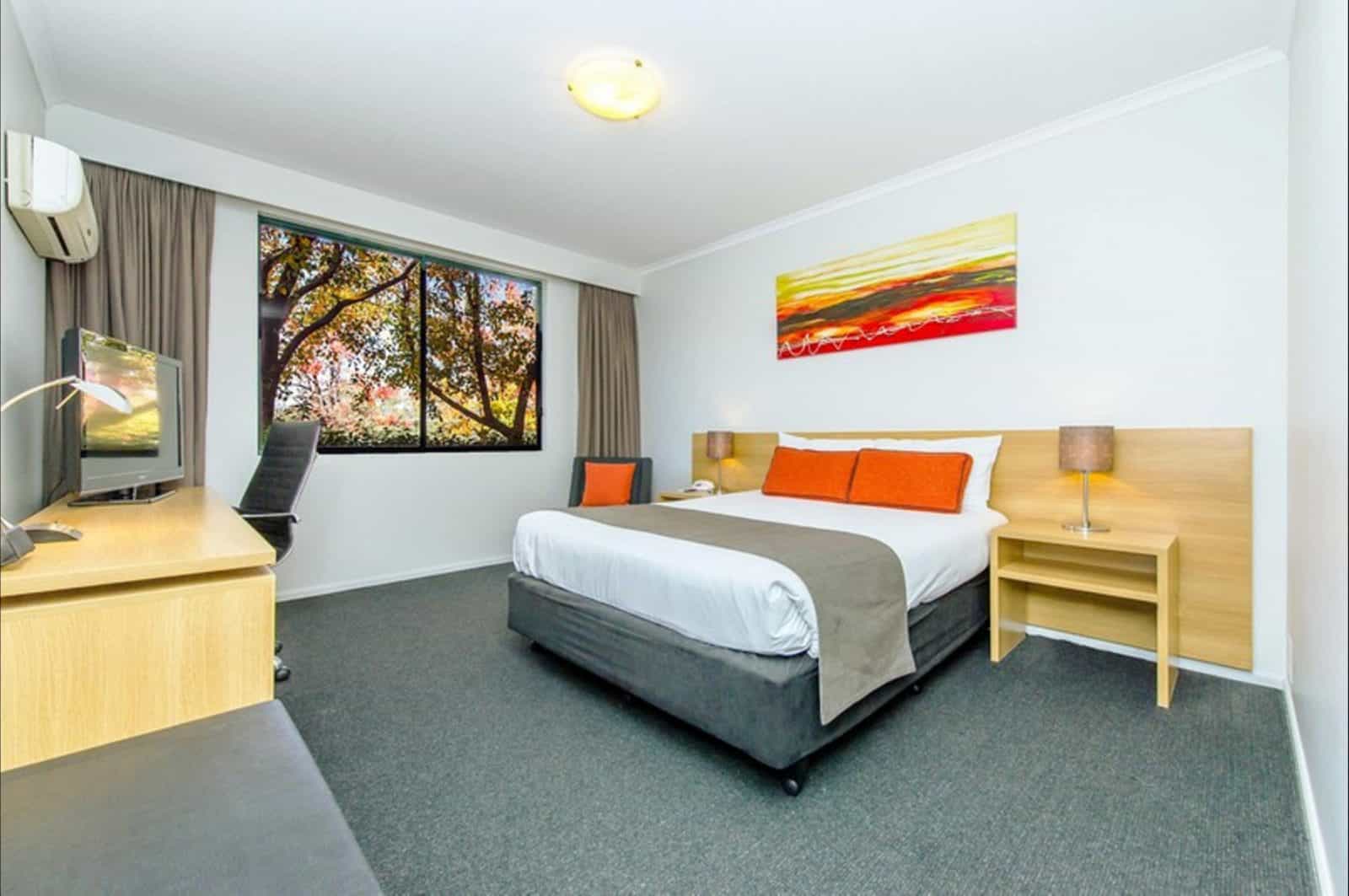 Deluxe Room interior with views of tree tops