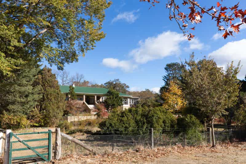 view of a heritage listed homestead amidst an autumnal garden
