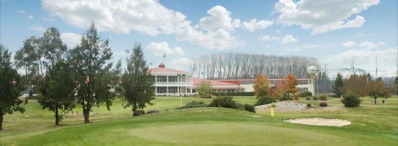 Wide view of Canberra International Golf Centre in the background and course in the foreground