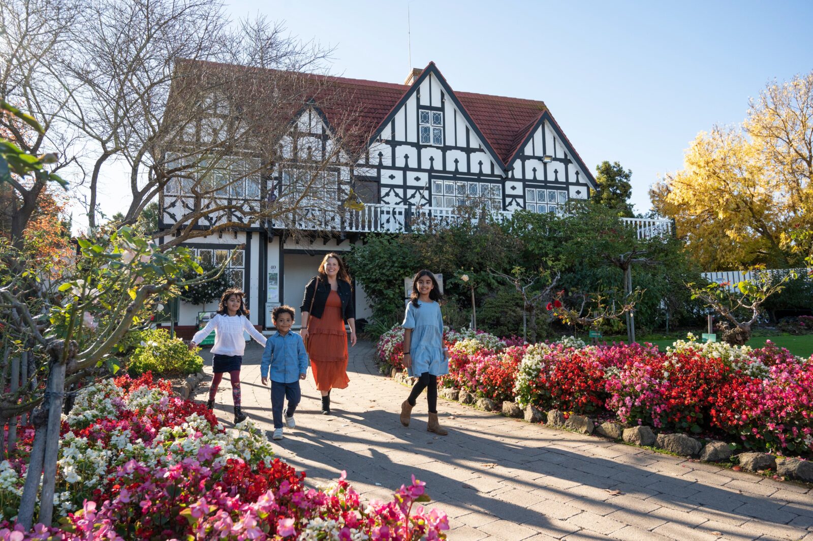 Family walks in front of a Tudor style architecture buidling