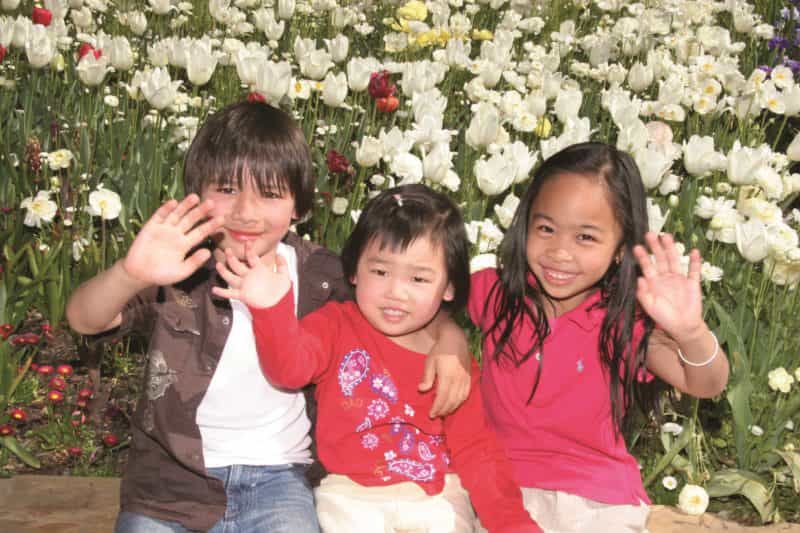 Children posing with the tulips at Floriade