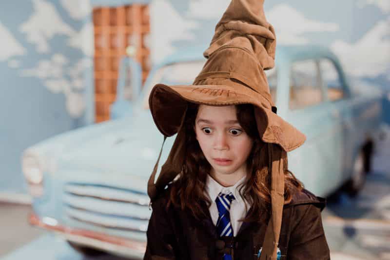 Young girl wearing a sorting hat