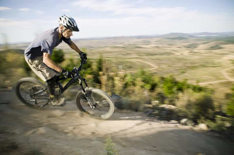 A man riding a mountain bike at Stromlo Forest Park