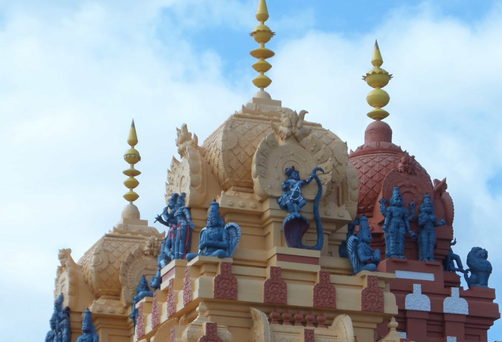Statues and spires atop the Vishni Siva Mandir Temple and Library