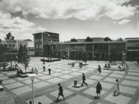 BW image of Canberra Civic square with people walking across square pavers