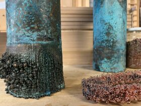 copper cylindrical forms with blue tarnish and growths