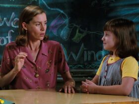 Still from Matilda showing a woman and a girl in a classroom in front of a chalkboard