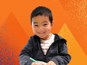 Photo of a young boy enjoying a crafting activity against a stylised pyramid orange background