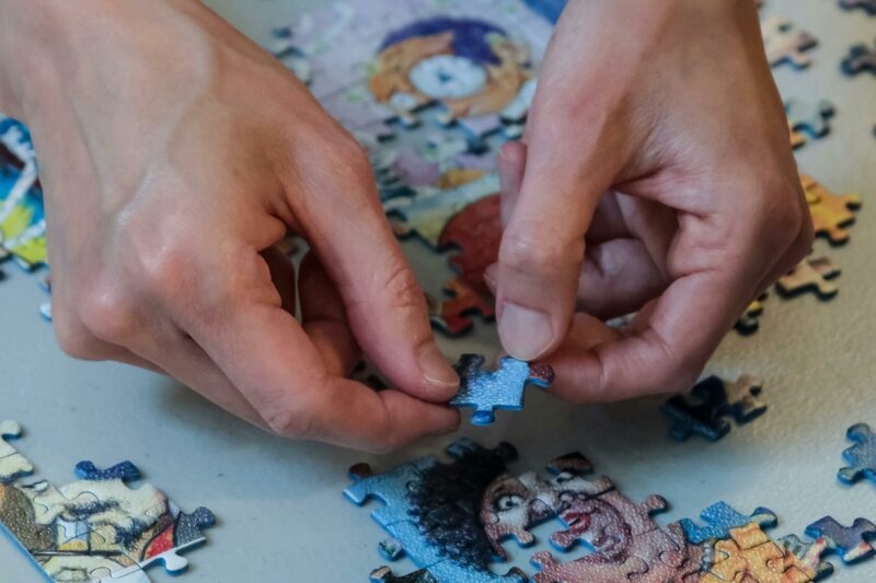 Hands completing a puzzle