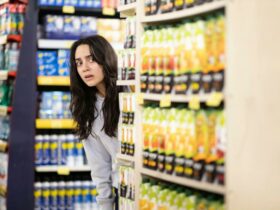 Still from The Persian Version showing a woman looking out from a supermarket aisle