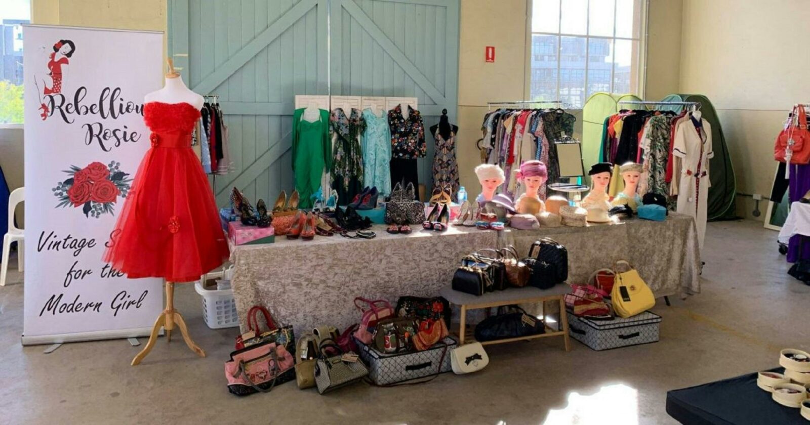 Stall showcasing colourful clothing and bags