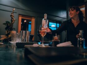Bartender pouring glass of wine