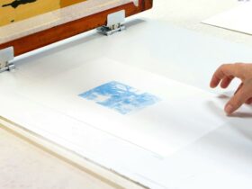 A photograph of a hand touching a screenprint