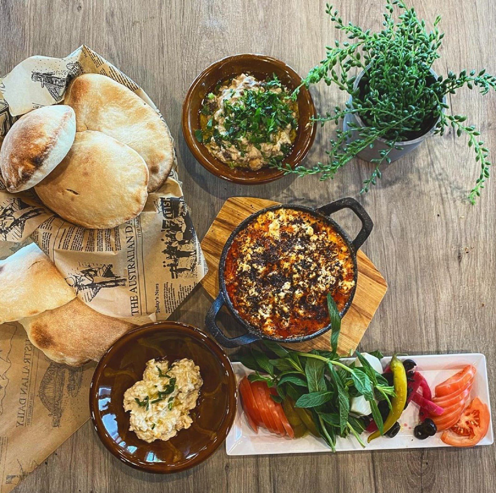 Spread of Lebanese food on wooden table