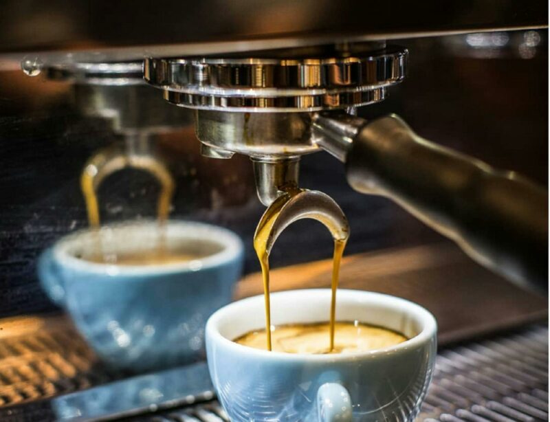 Coffee being brewed into a pale blue coffee cup