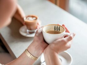 Person holding coffee cup with two hands